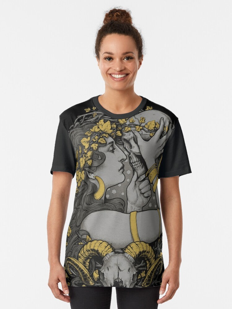 A gothic graphic t-shirt featuring a witch design with a ram skull, human skull, and botanical elements - Women