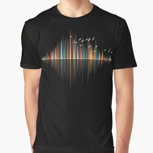 A minimalist graphic t-shirt design featuring a colorful sound wave silhouette with birds flying against a sunset background.