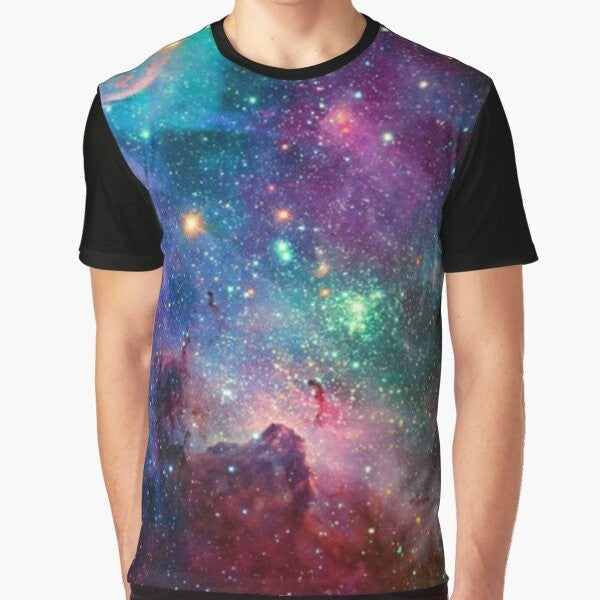 A colorful graphic t-shirt featuring a galaxy design with planets, stars, and cosmic elements.