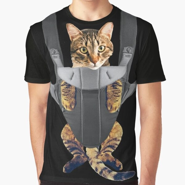 A funny graphic t-shirt design featuring a cat in a baby carrier.