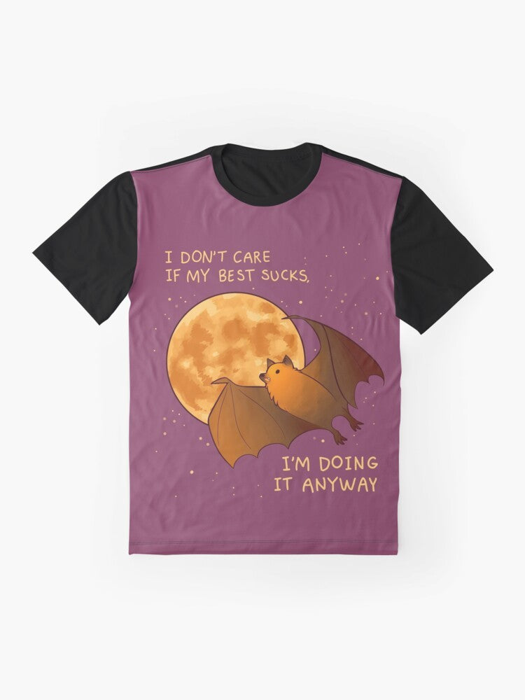 A t-shirt with a graphic design of a flying fox bat against a night sky filled with stars, representing mental health, encouragement, and self-care. - Flat lay