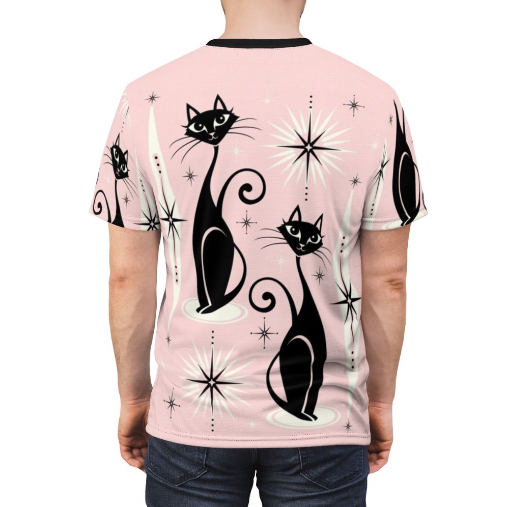 Model wearing a pink t-shirt with a mid-century modern atomic cat graphic design - men back