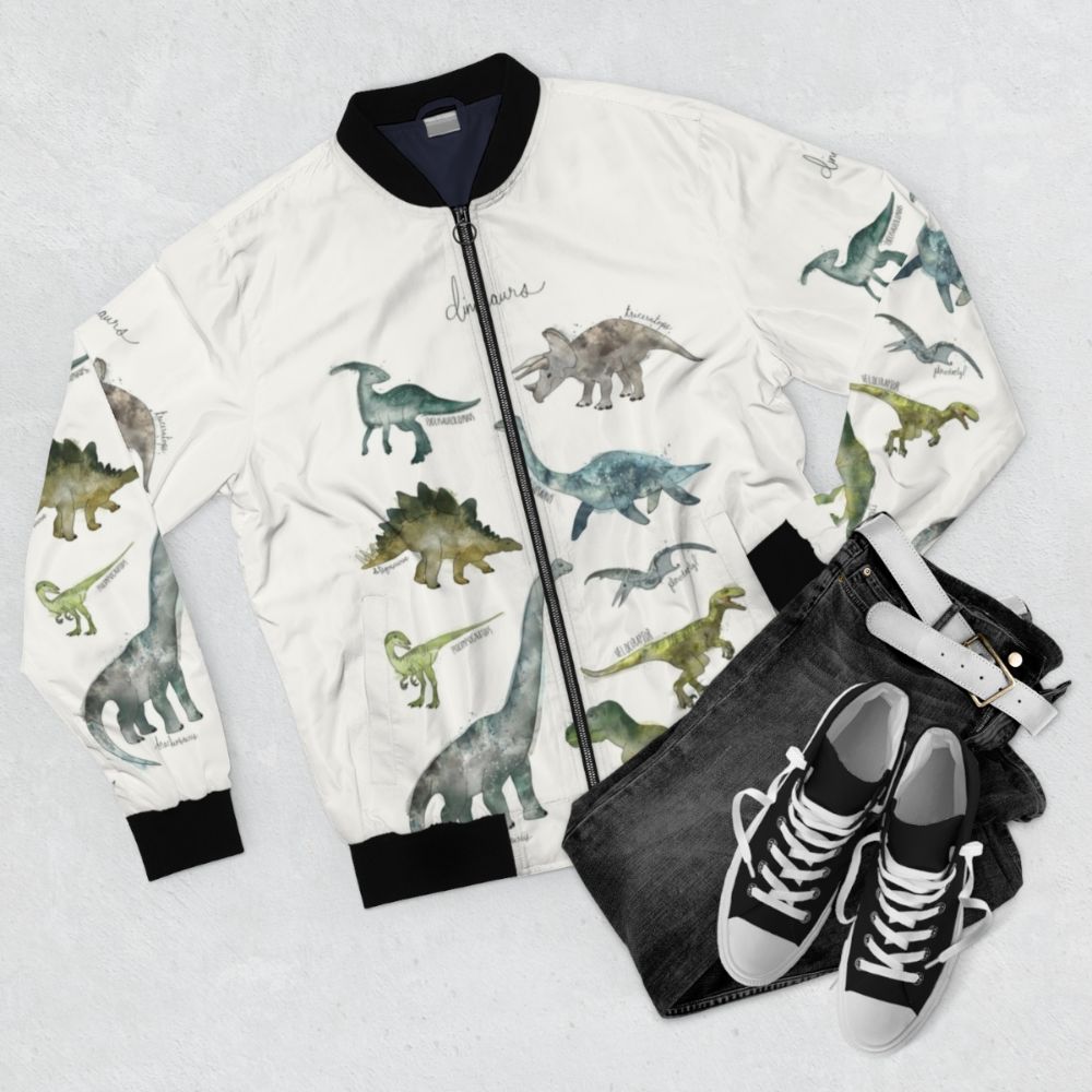 A stylish bomber jacket featuring a vibrant dinosaur design, perfect for nature and animal enthusiasts. - Flat lay