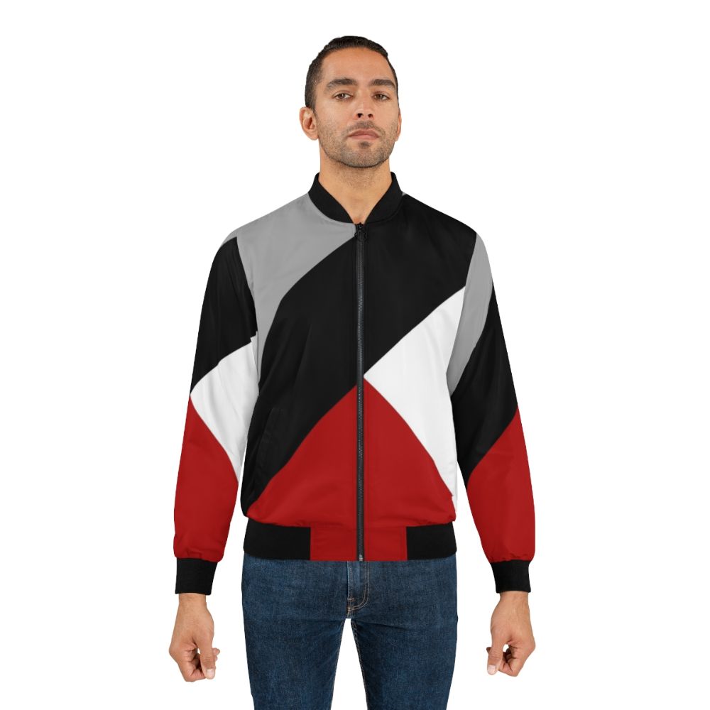 Black bomber jacket with diagonal stripes and triangular geometric pattern, a modern and minimalist design. - Lifestyle