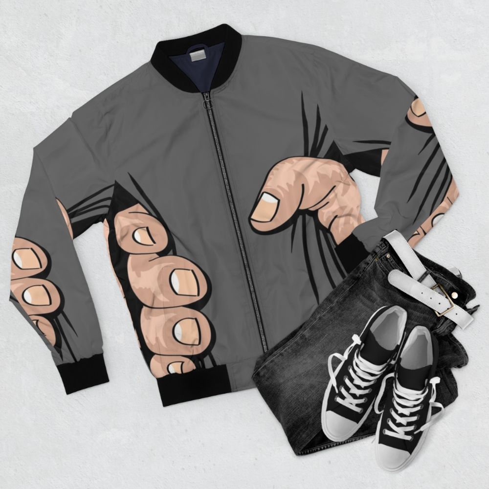 A bomber jacket featuring an illustration of a giant hand squeezing and grabbing the wearer. - Flat lay