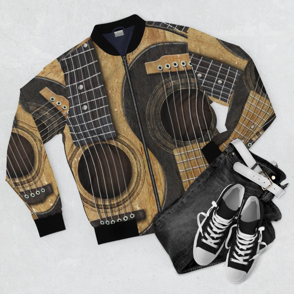 Vintage-inspired bomber jacket featuring a yin yang design made of old, worn acoustic guitars - Flat lay