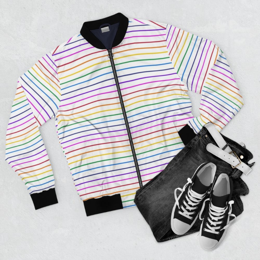 A white bomber jacket with bright horizontal rainbow stripes. - Flat lay