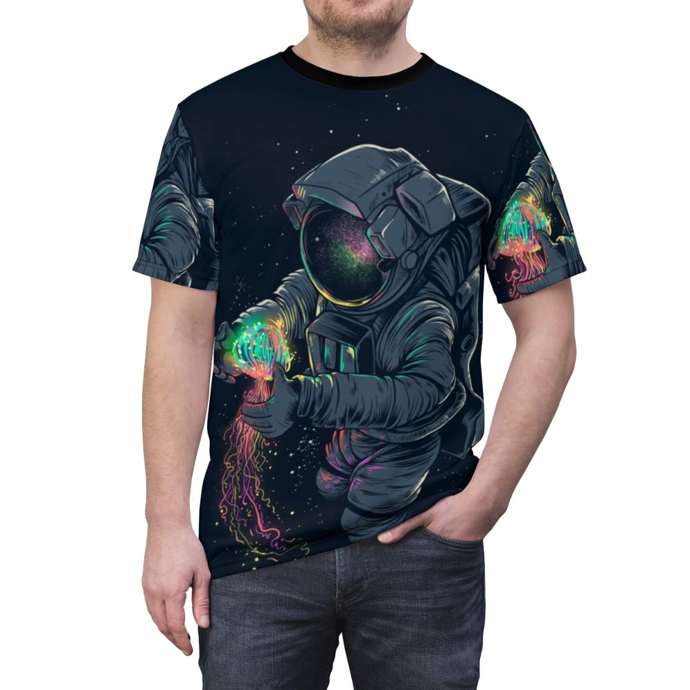 Model wearing a t-shirt featuring a colorful, intergalactic jellyfish design against a starry space backdrop. - men front