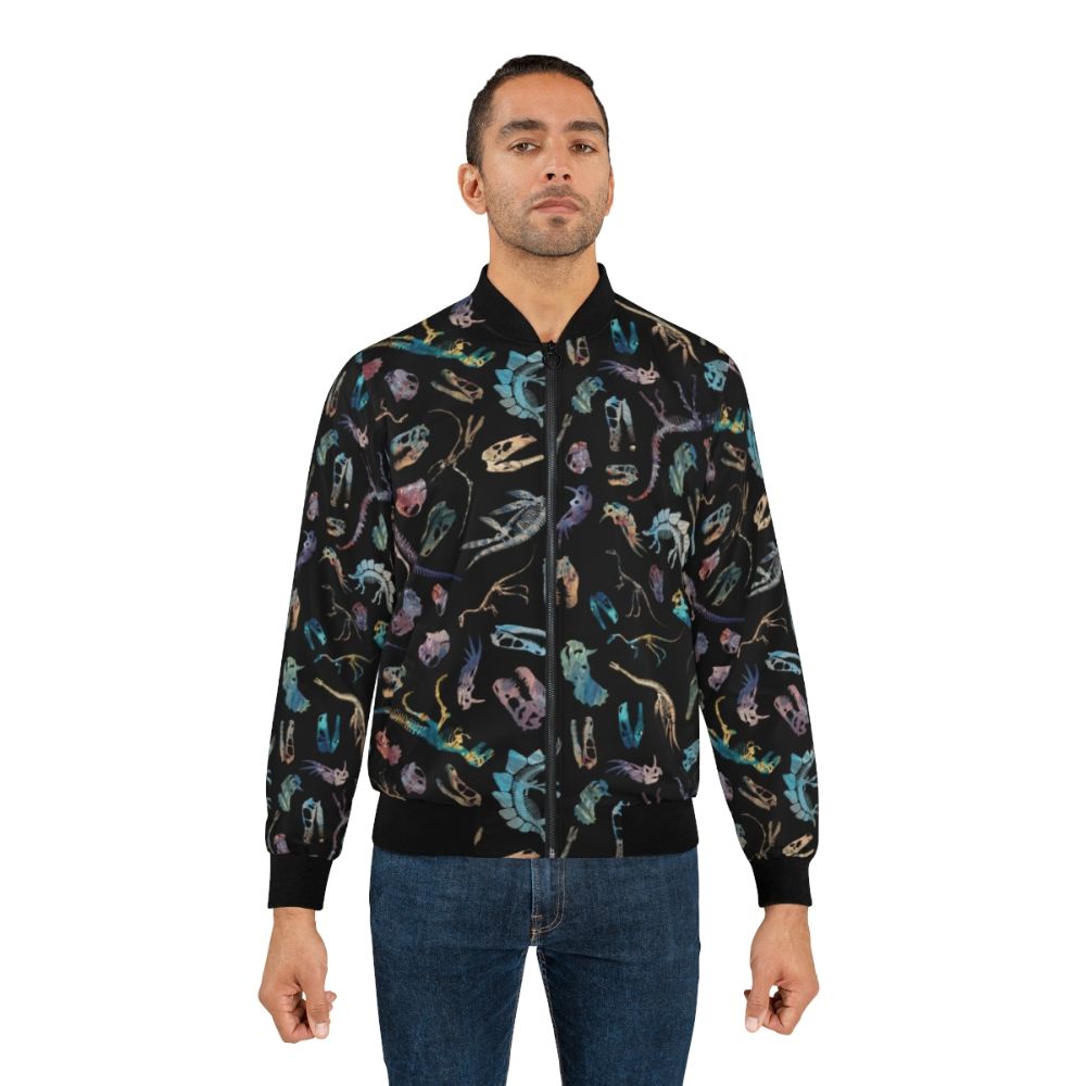 Dark bomber jacket with a dinosaur fossil and skeletal pattern design, perfect for science and paleontology enthusiasts. - Lifestyle