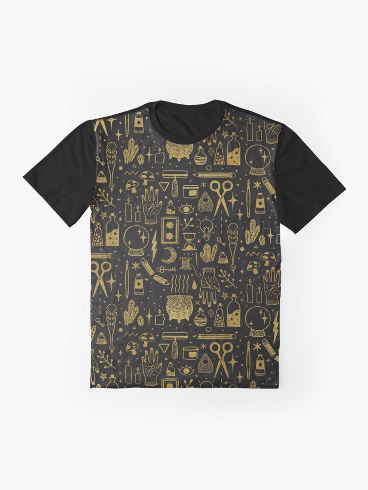 A gold and black graphic t-shirt featuring the words "Make Magic" with occult and witchy elements like a cauldron, mushrooms, and tarot cards. - Flat lay