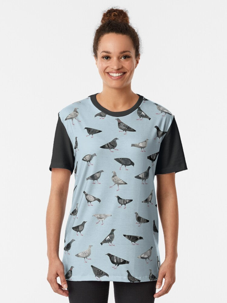 Graphic t-shirt featuring a design of urban pigeons or doves in a flock, with a pattern of gray and white birds. - Women