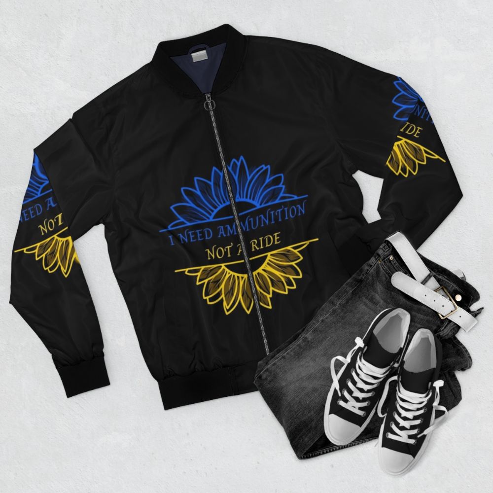 A blue and yellow bomber jacket with a sunflower design, representing the colors of the Ukrainian flag. - Flat lay