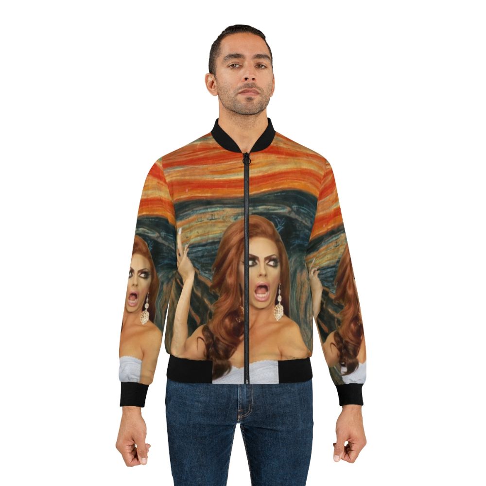 Alyssa Edwards wearing a colorful bomber jacket with her iconic catchphrase "Backrolls?" printed on the back - Lifestyle