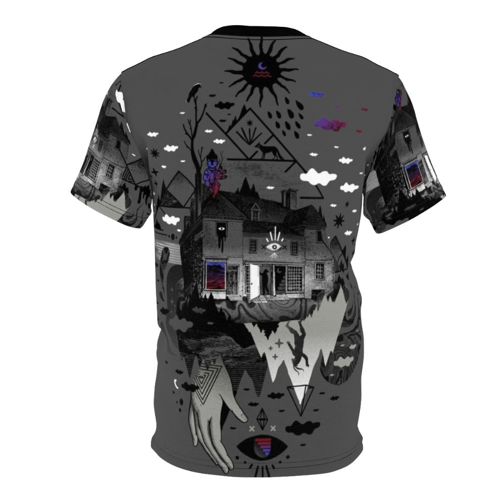 A surreal and abstract t-shirt design featuring a collage of dark mountain shapes, stars, moon, and other symbolic elements. - Back