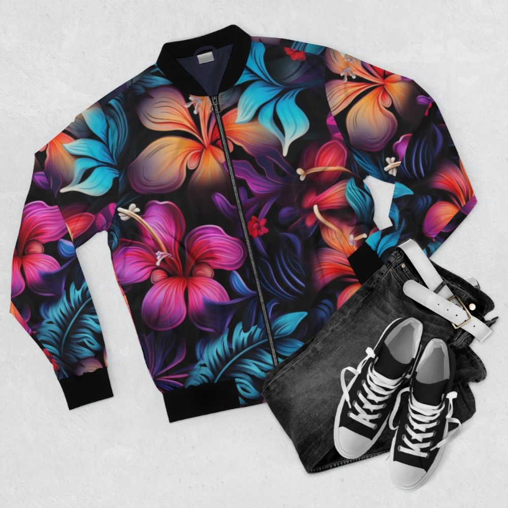 Model wearing a dark Hawaiian pattern bomber jacket with tropical flowers and bioluminescent designs - Flat lay