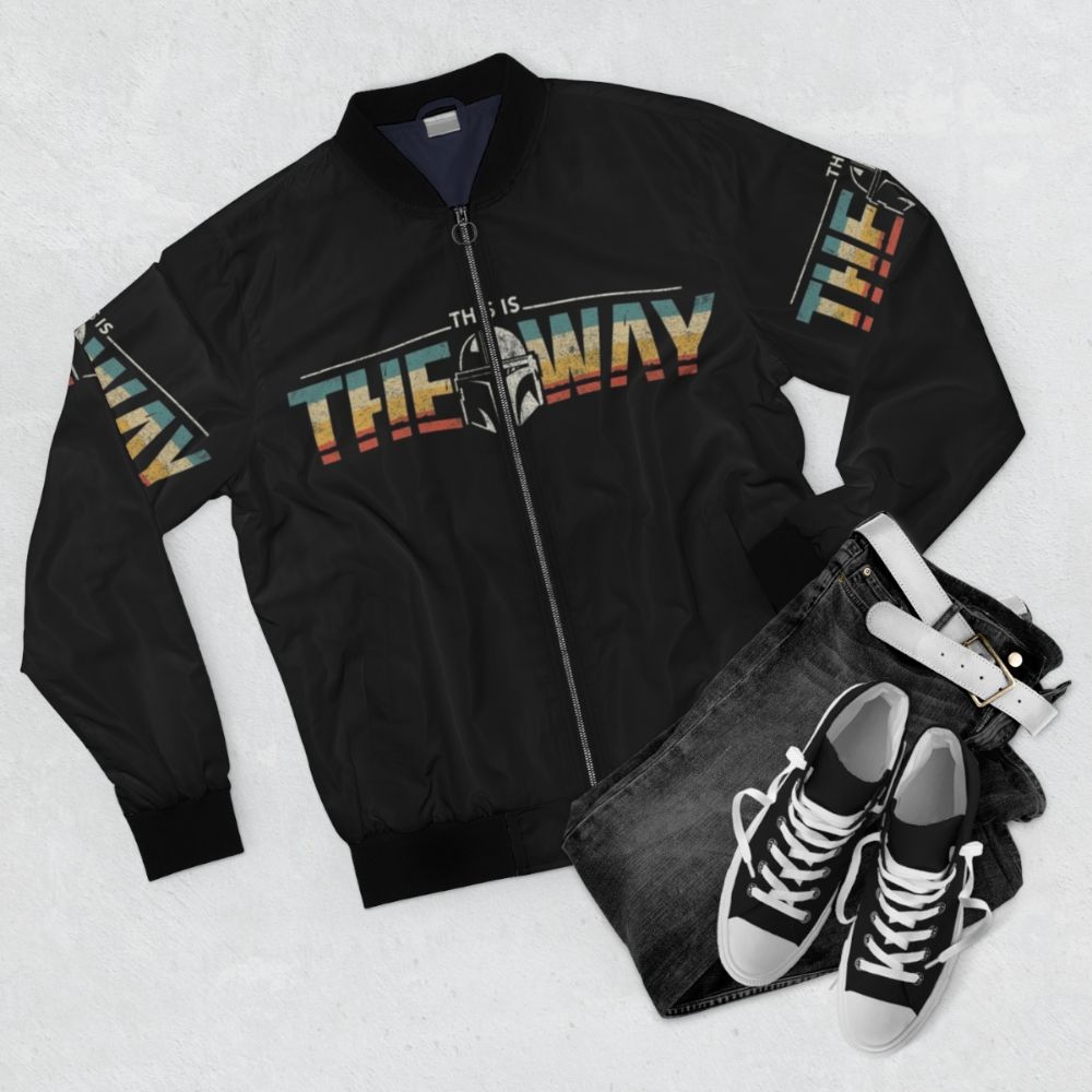 A stylish bomber jacket featuring the "This is the Way" quote and design elements from the Star Wars Mandalorian series. - Flat lay