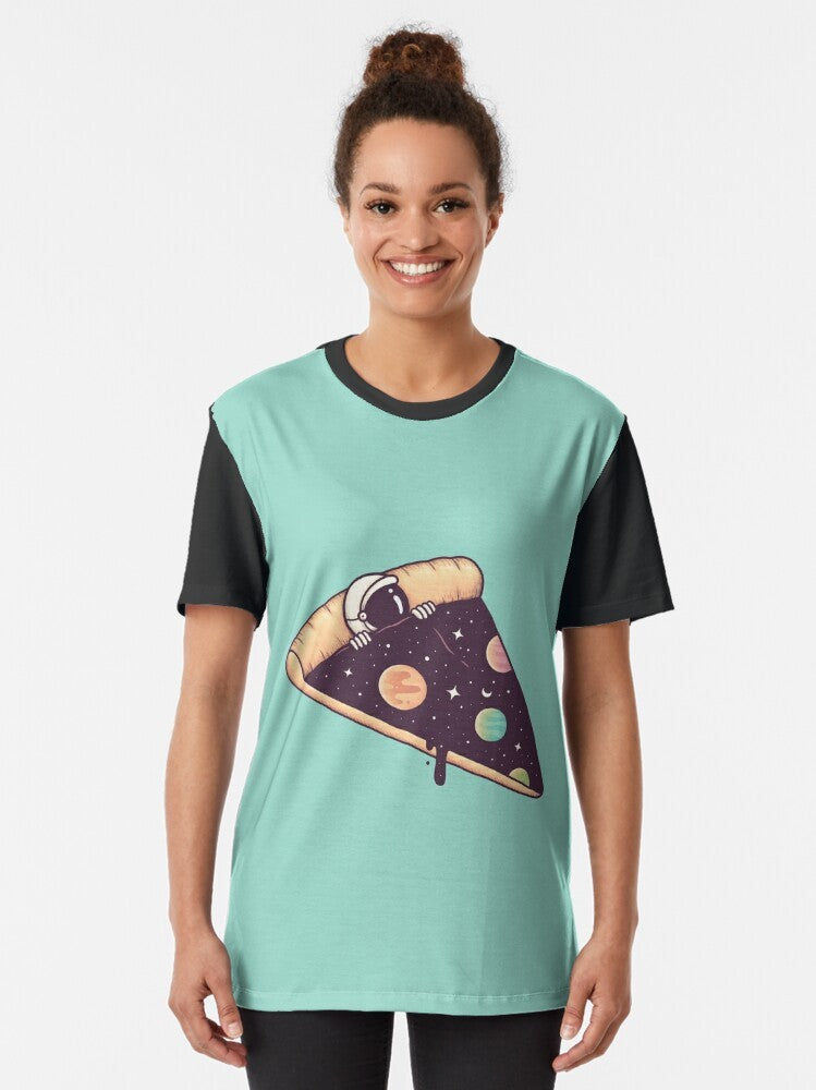 Graphic t-shirt featuring a surreal design of an astronaut enjoying a slice of pizza in the vast cosmos - Women