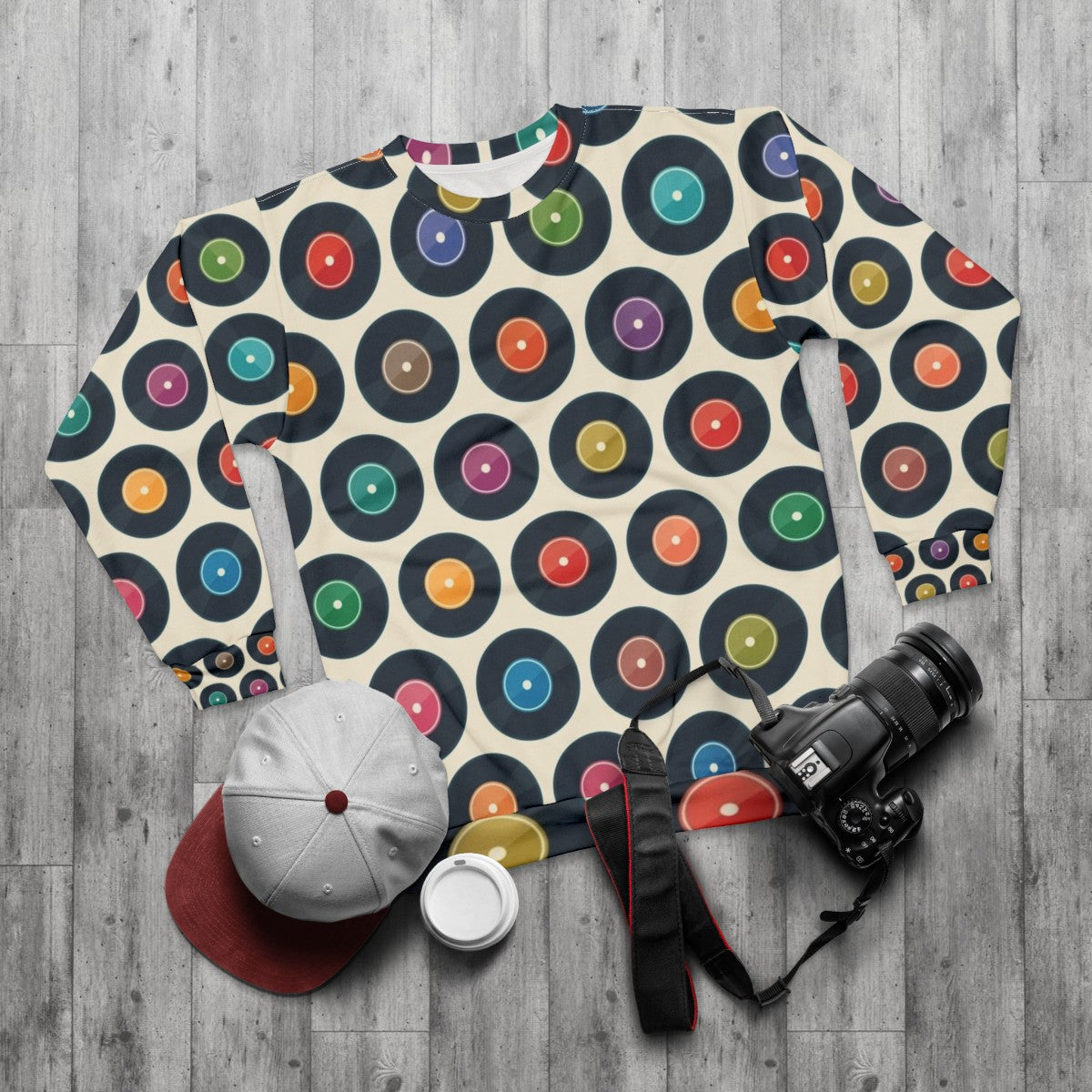 Vintage-style sweatshirt featuring a collection of classic vinyl records - flat lay