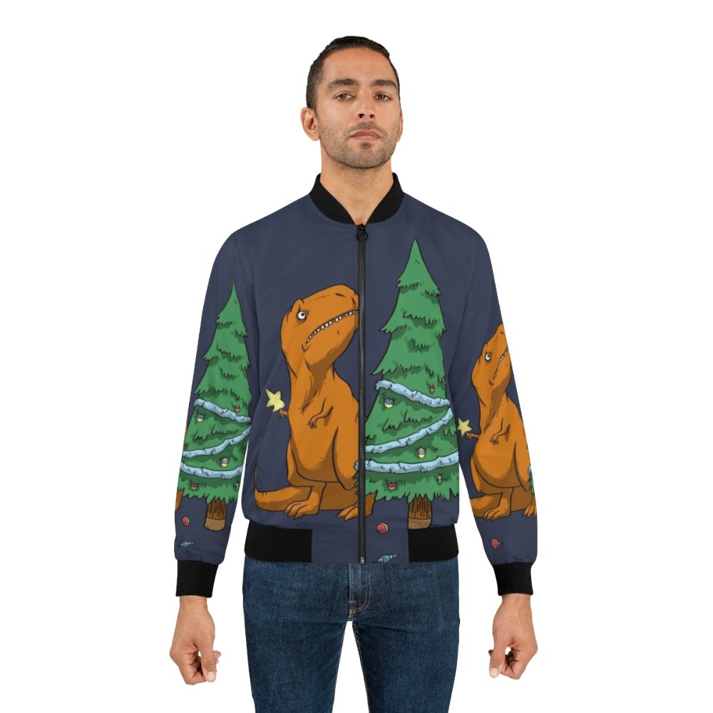 A funny t-rex bomber jacket with tiny arms and a festive holiday design, perfect for kids during the winter season. - Lifestyle