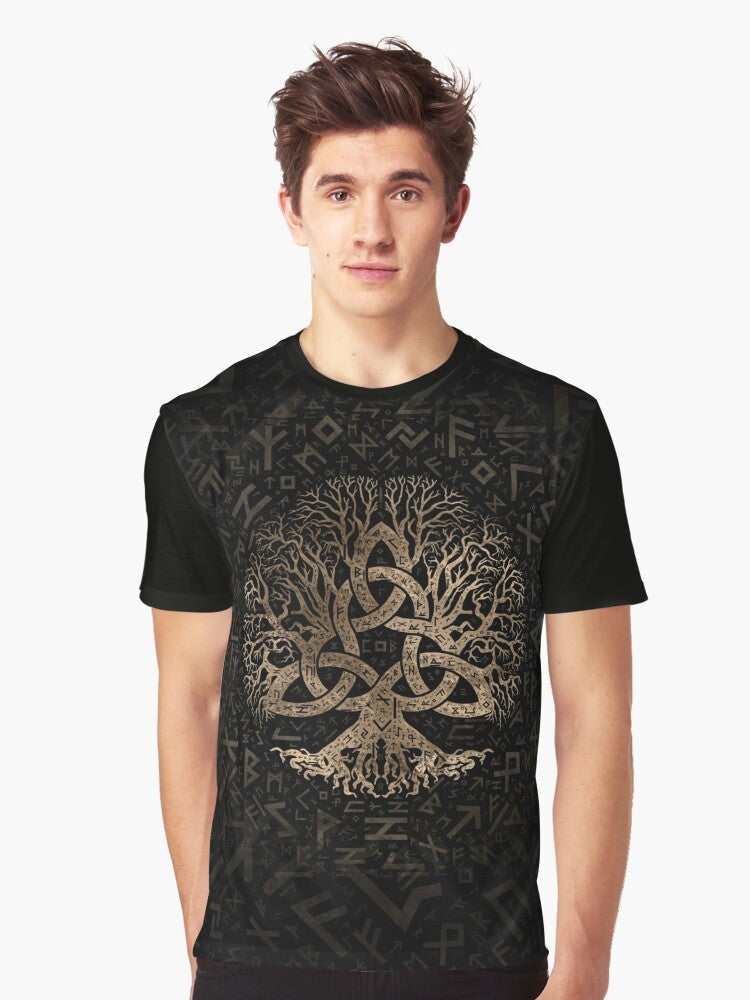 Graphic tee featuring a tree of life design with a triquetra and Futhark rune pattern in gold and black. - Men