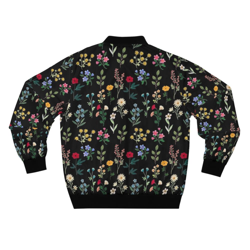 A black bomber jacket featuring a vibrant floral and botanical watercolor pattern design. - Back