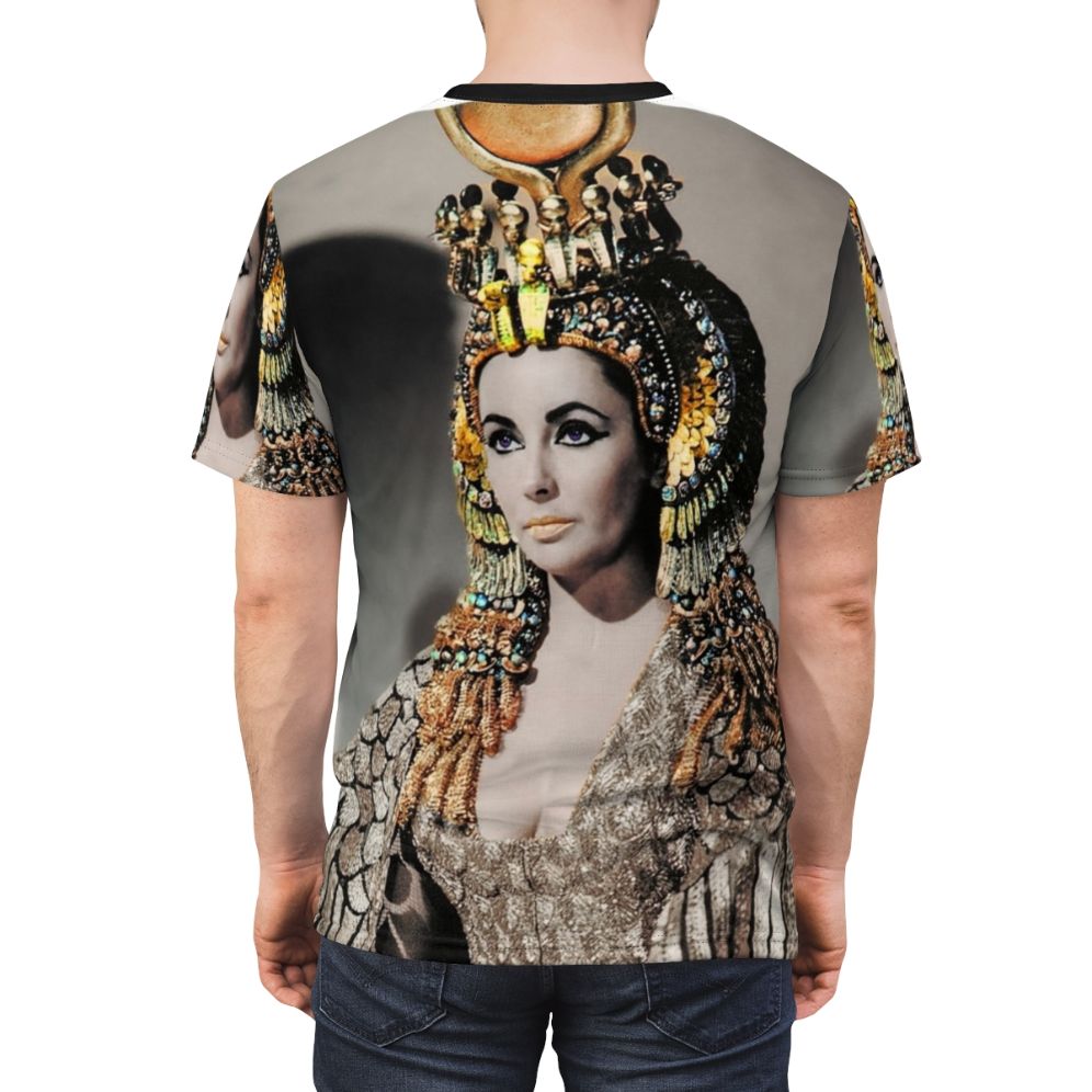 A person wearing a T-shirt featuring a stylized portrait of Elizabeth Taylor as Cleopatra in ancient Egyptian attire. - men back