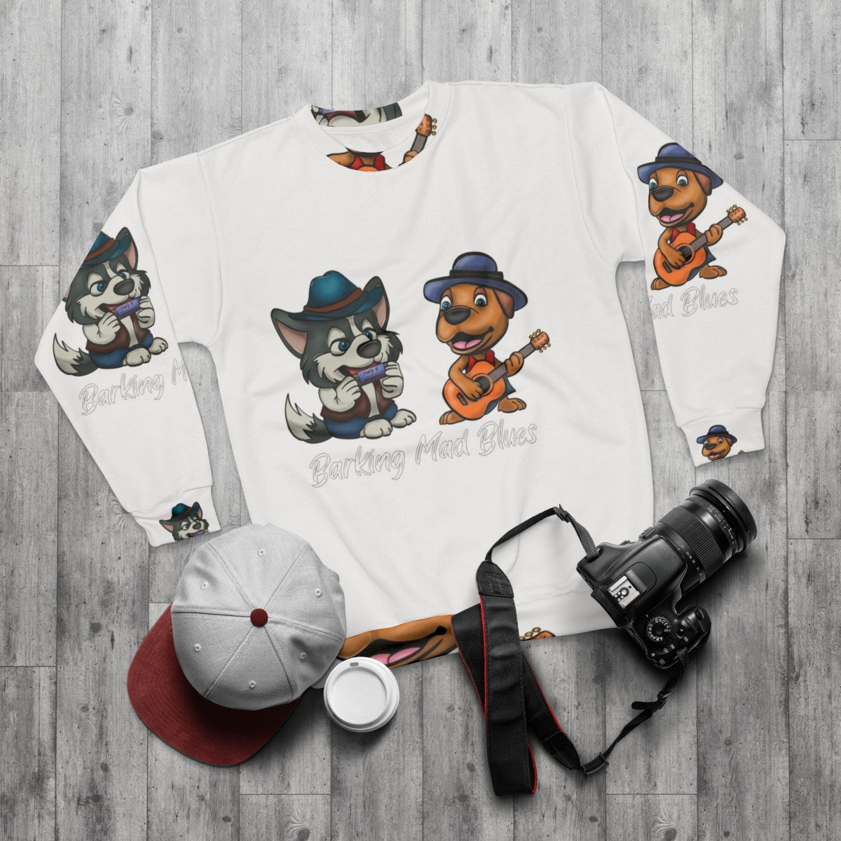 Blues sweatshirt featuring a cartoon malamute musician - flat lay