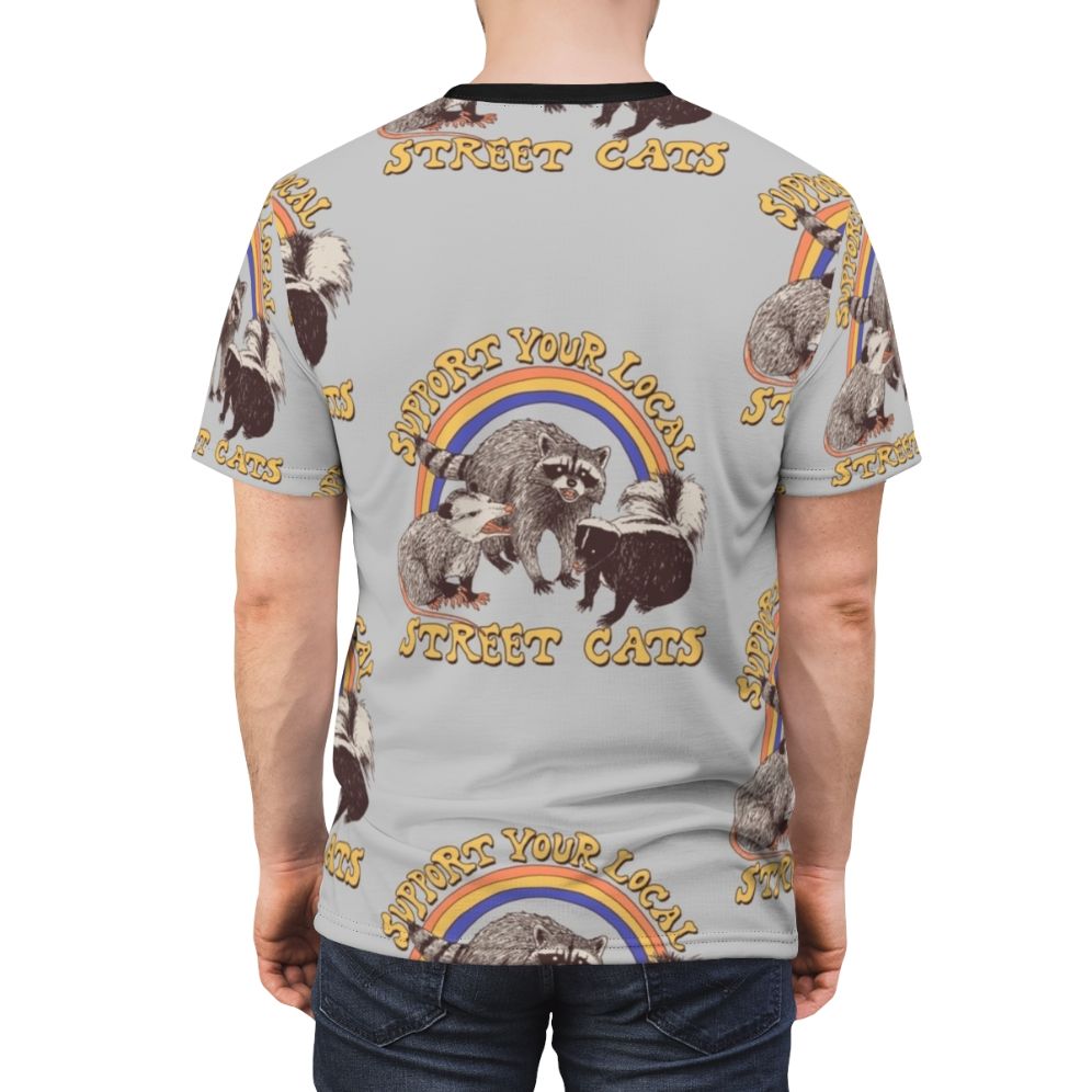 Retro-style AOP t-shirt featuring a colorful design of cats, possums, skunks, and raccoons in a fun, urban setting. - men back