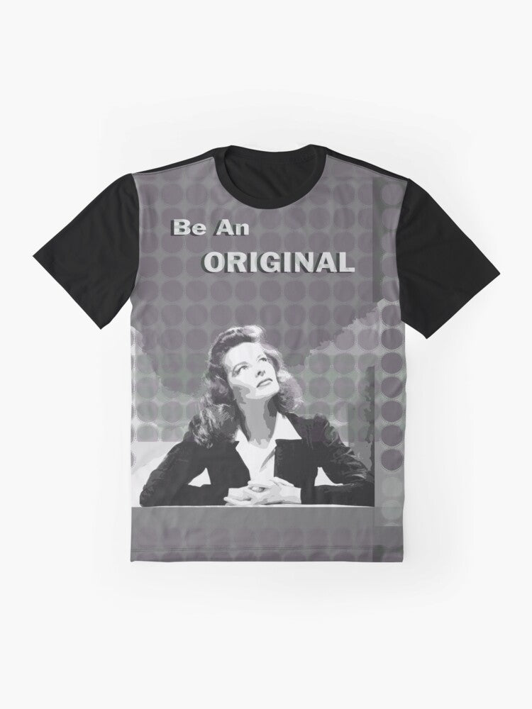 Graphic t-shirt with a portrait illustration of Katharine Hepburn, a famous movie star known for her iconic fashion style and trouser suits. - Flat lay