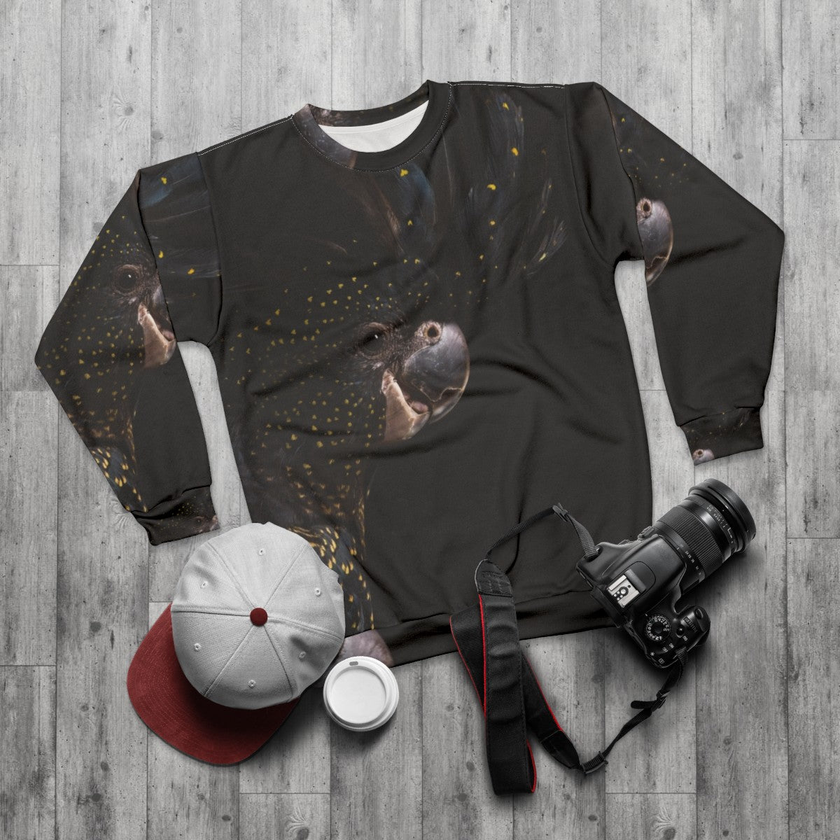 Red tailed black cockatoo bird on a sweatshirt - flat lay