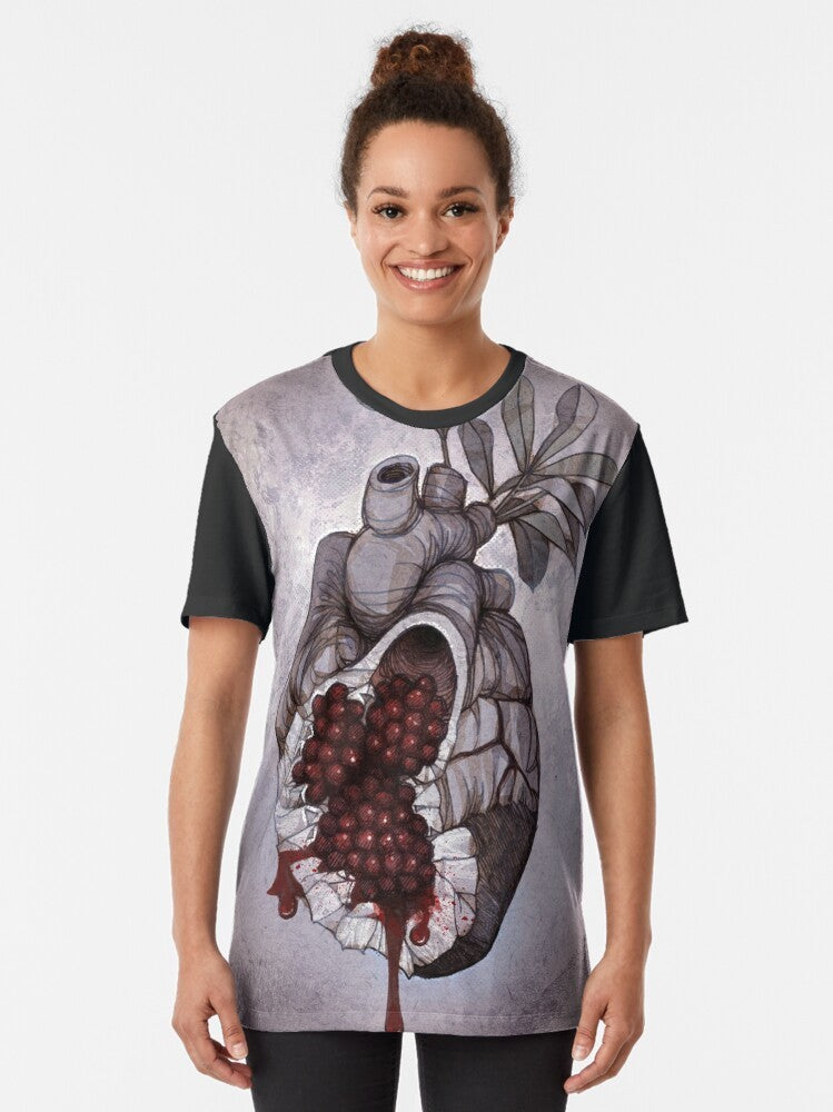 Graphic t-shirt featuring an anatomical illustration of a human heart with pomegranate seeds, inspired by the Greek mythology of Persephone. - Women