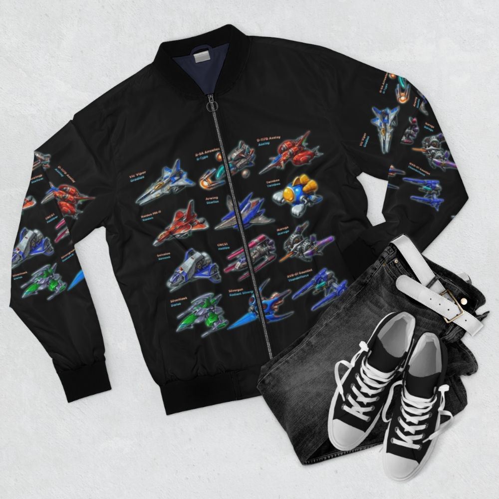 Retro bomber jacket with shmup, arcade, and gaming graphics - Flat lay