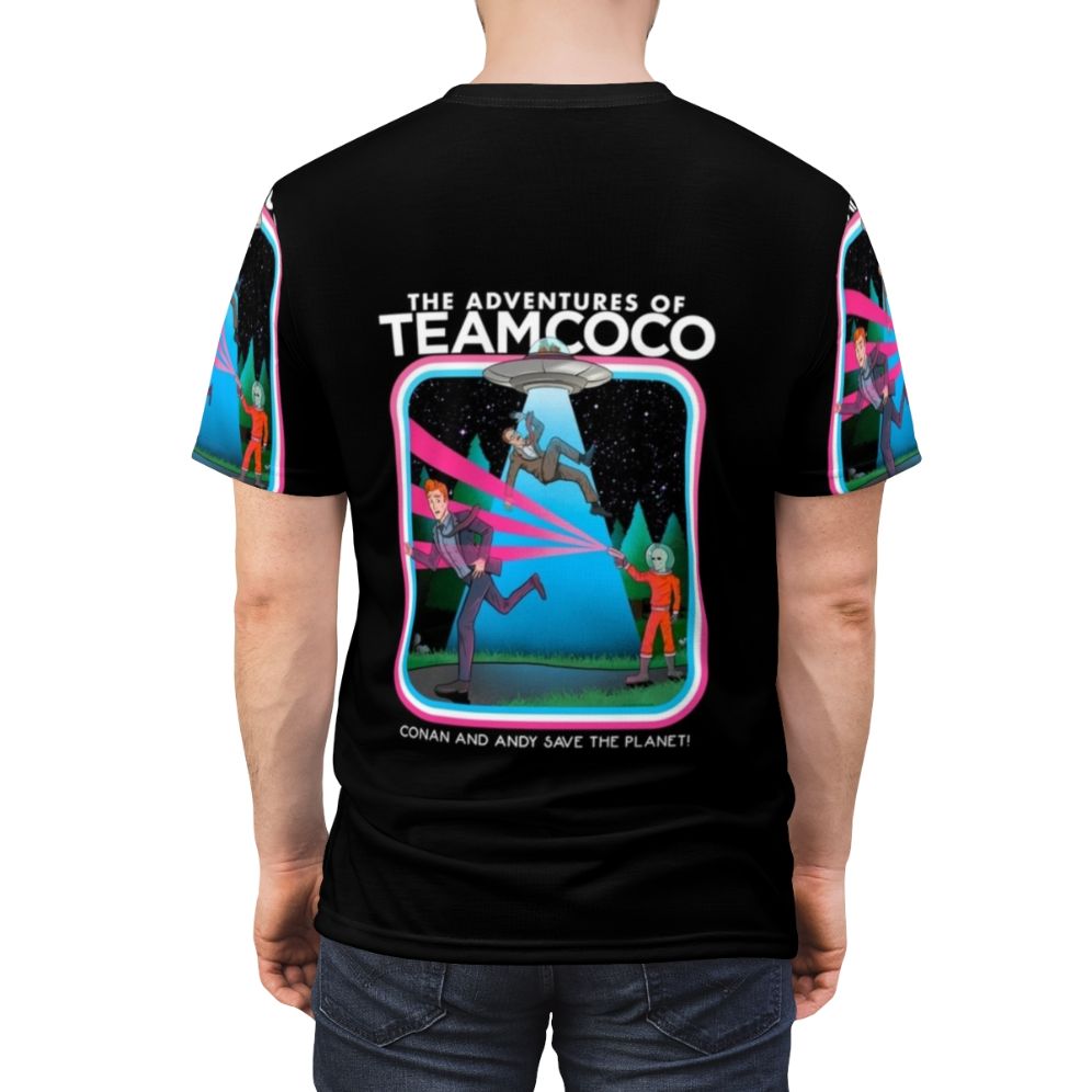 A t-shirt design featuring a comedic alien abduction scene, inspired by the popular Team Coco brand. - men back