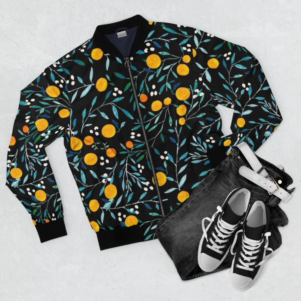 Watercolor orange floral pattern on a black bomber jacket - Flat lay