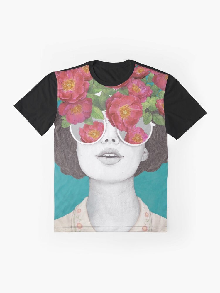 A surrealist graphic t-shirt featuring a woman's face with rose tinted glasses, surrounded by a watercolor floral design. - Flat lay