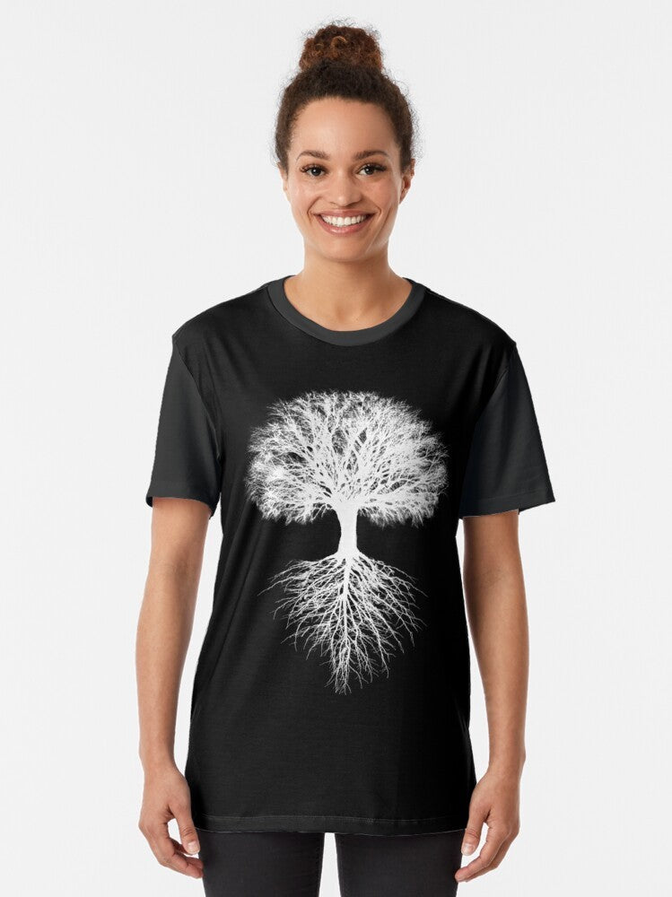 A graphic t-shirt featuring a stylized tree of life design, representing the interconnectedness of nature and the environment. - Women