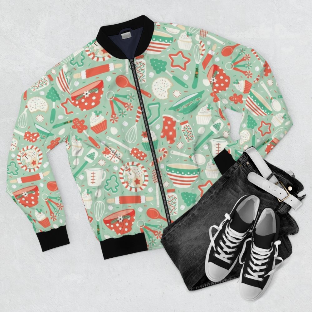 A cozy bomber jacket featuring festive Christmas baking and cookie designs, perfect for the holiday season. - Flat lay