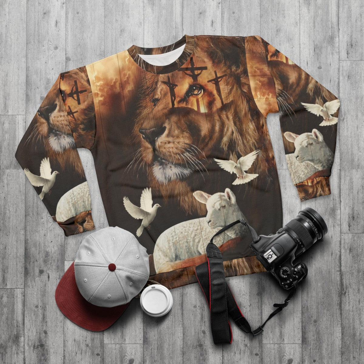 Christian sweatshirt with a design featuring the Lion of Judah and the Lamb of God - flat lay