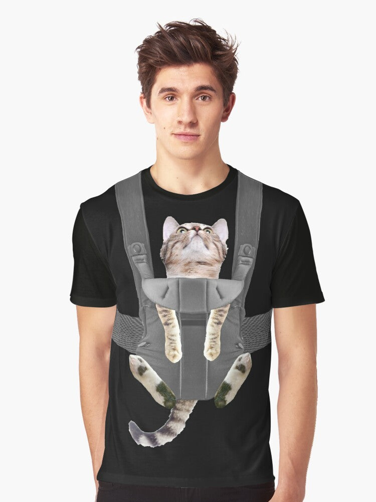 A tabby cat sitting in a baby carrier on a graphic t-shirt - Men