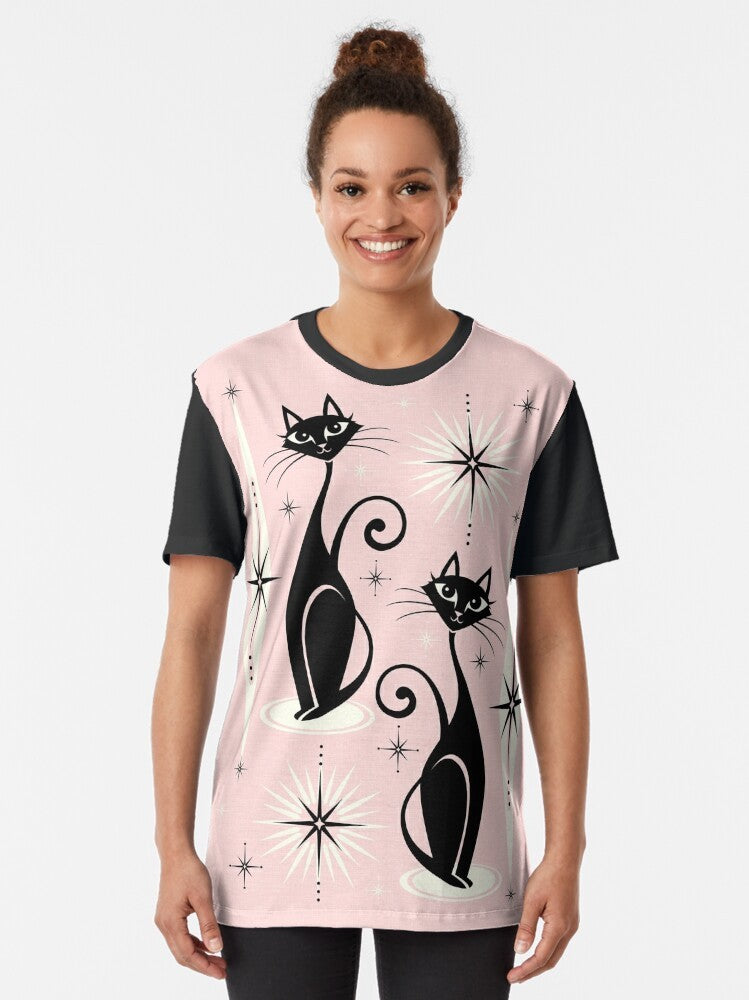 Mid century modern graphic t-shirt featuring atomic-inspired cats and starbursts in a warm pink design - Women