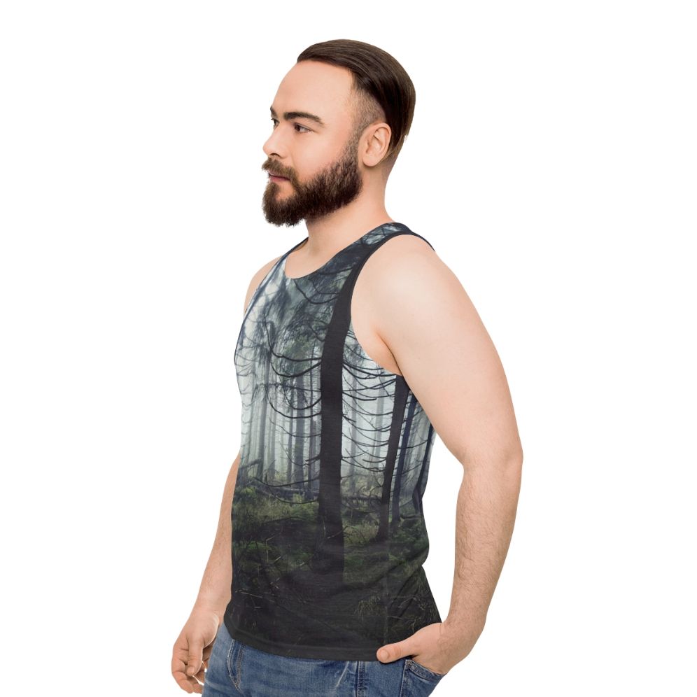 Person wearing unisex nature tank top standing in a forest - men side