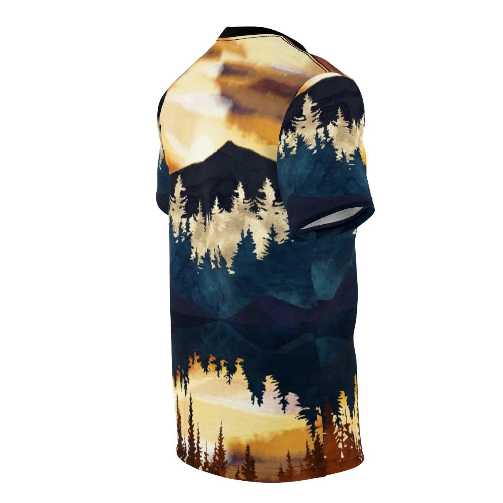 A t-shirt featuring a vibrant, watercolor-style landscape design with a beautiful fall sunset over a lake, surrounded by forests and mountains. - men right