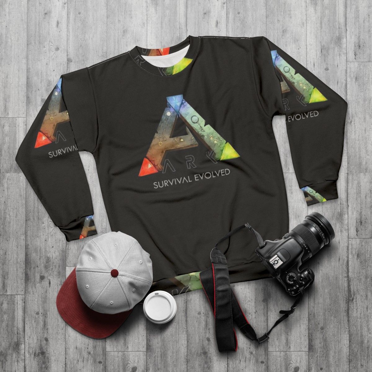 Ark Survival Evolved Sweatshirt featuring dinosaurs and video game logo - flat lay