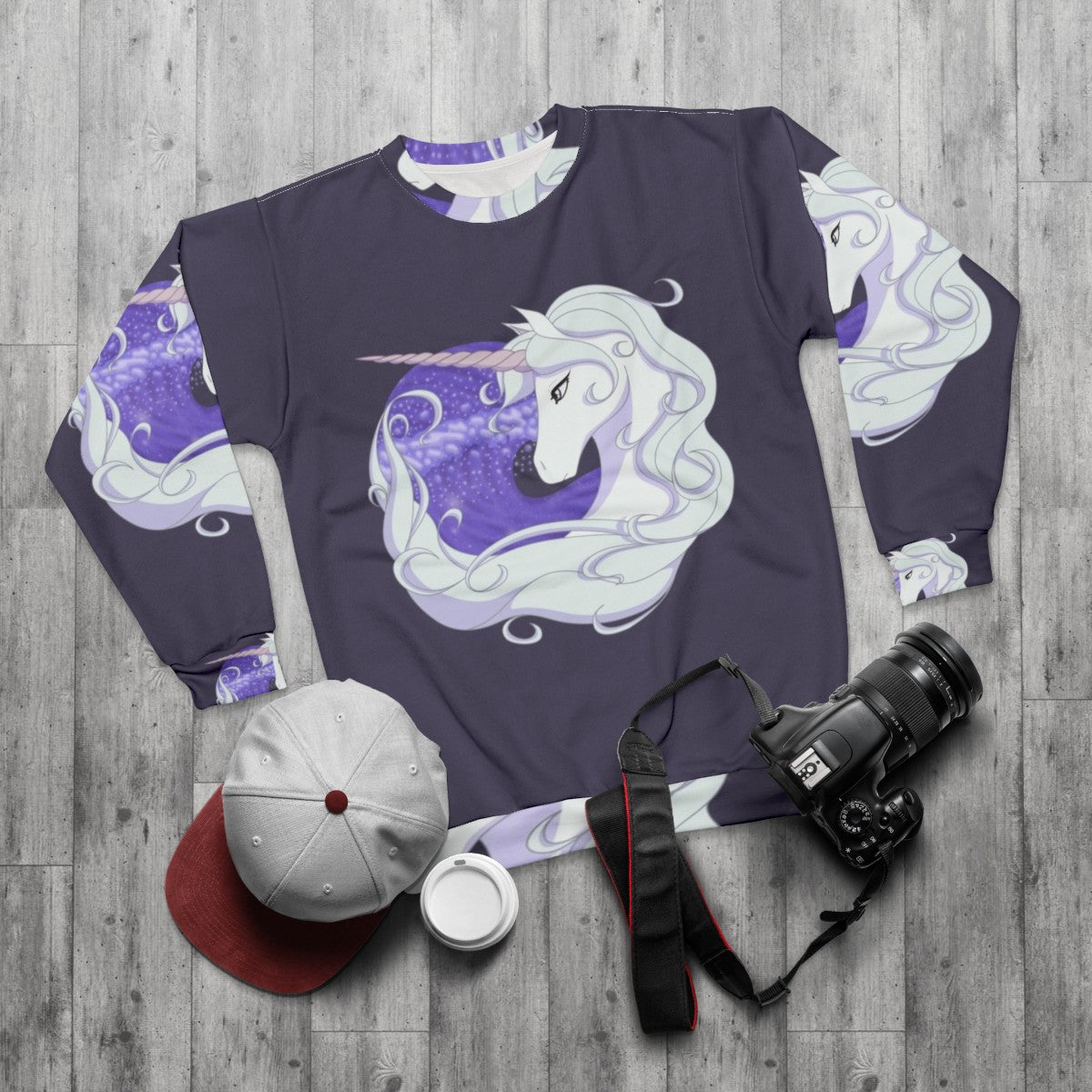 The Last Unicorn sweatshirt featuring a mythical unicorn swimming through ocean waves - flat lay