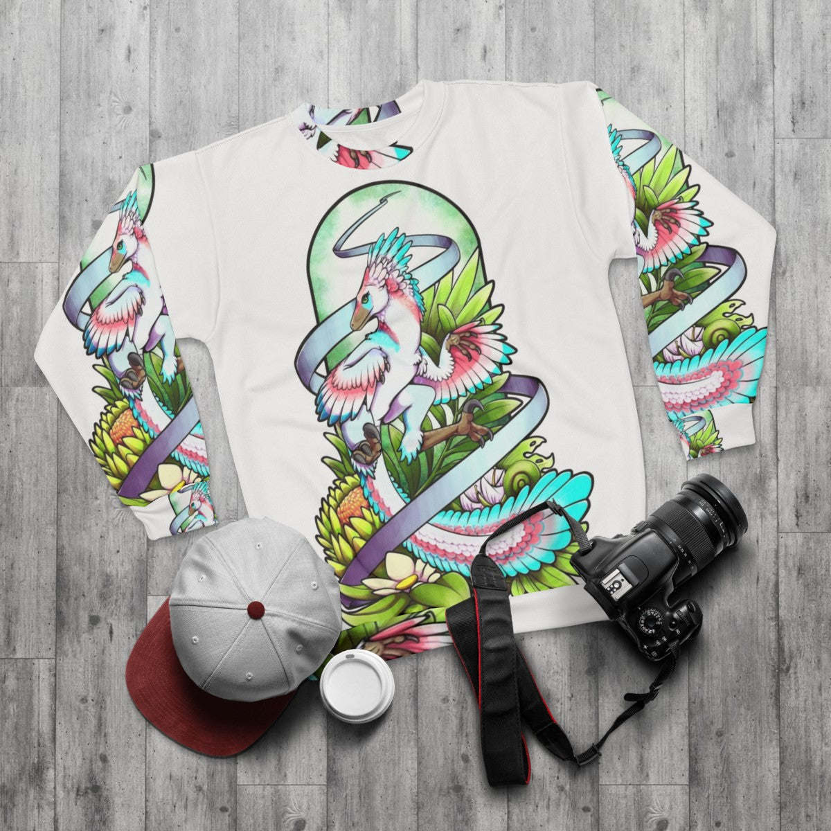 Sylveraptor dinosaur raptor sweatshirt with nature inspired design - flat lay