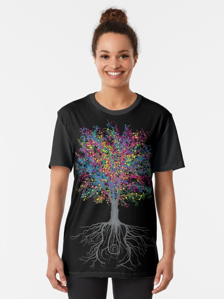 A graphic t-shirt design featuring a nature-inspired pattern with musical notes and elements like trees, leaves, and blossoms. - Women