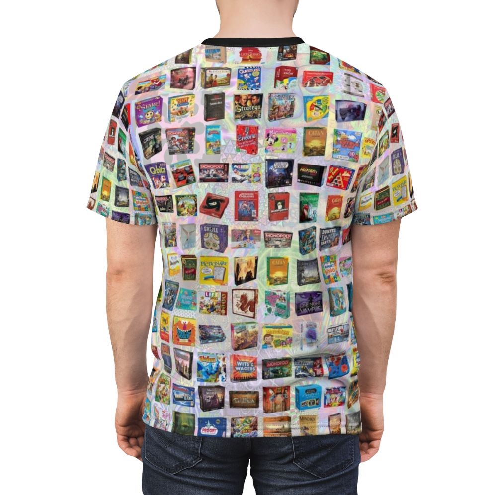 Model wearing a t-shirt featuring an all-over print design with various board game pieces and elements. - men back