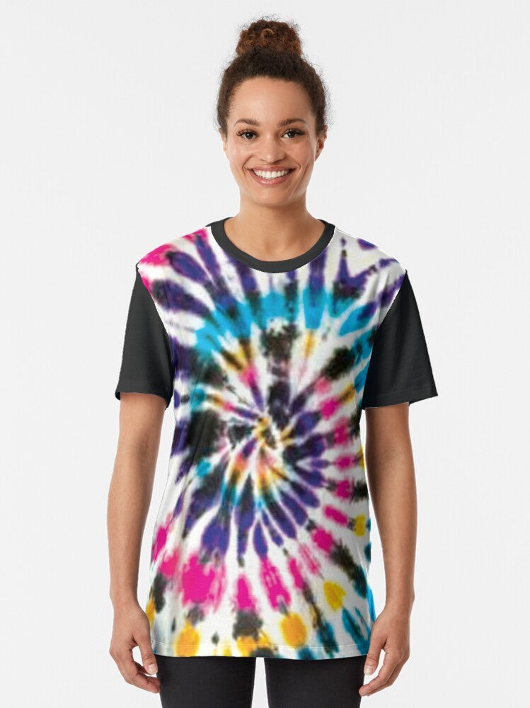 Colorful spiral tie dye graphic design on a t-shirt featuring black, white, purple, yellow, pink, and cyan colors. - Women