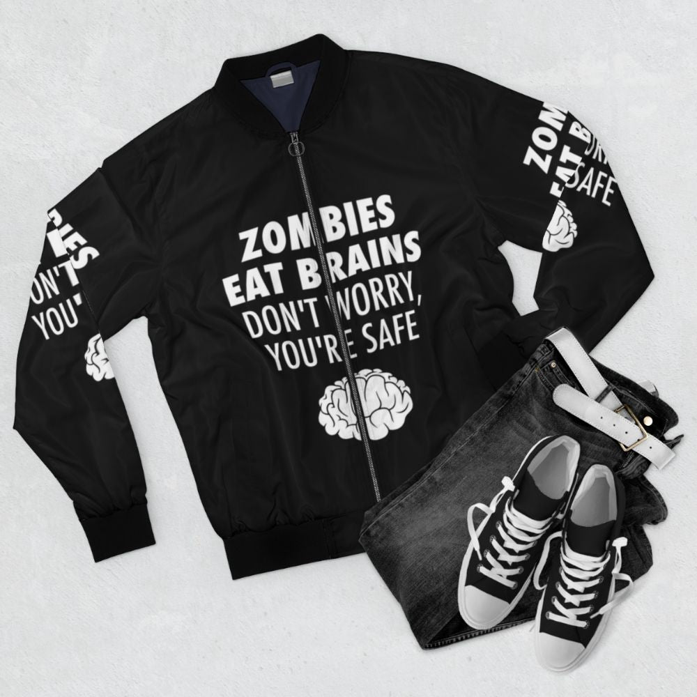 Zombie-themed bomber jacket with the text "Zombies Eat Brains, You're Safe" - Flat lay