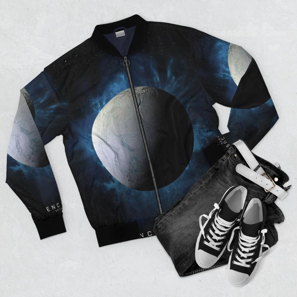 Enceladus space-themed bomber jacket with Saturn, moon, and cosmic elements - Flat lay